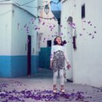 Urban Child - falling petals under girl