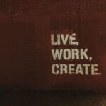 Urban Art - red brick wall with live, work, create. quote