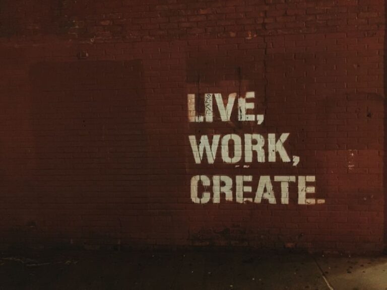 Urban Art - red brick wall with live, work, create. quote