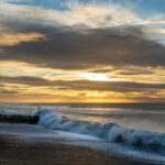 Wave Energy - ocean waves crashing on shore during sunset