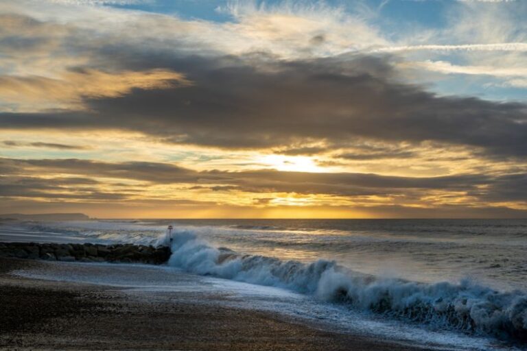 Wave Energy - ocean waves crashing on shore during sunset