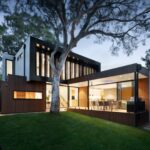 Modern Architecture - brown and white wooden house near green trees during daytime