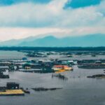 Flooding - houses surrounded with water under cloudy sky