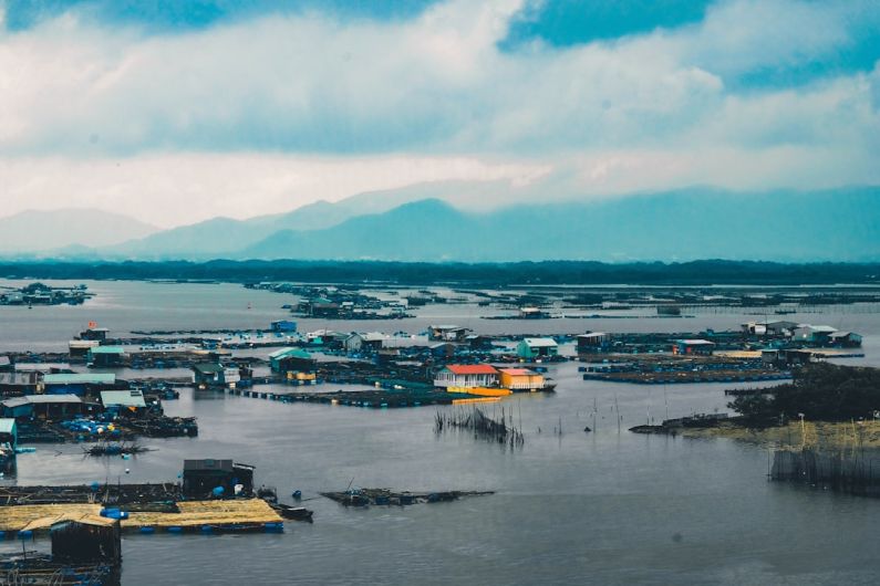 Flooding - houses surrounded with water under cloudy sky