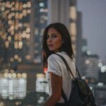 Older Buildings - woman in white t-shirt carrying black leather backpack