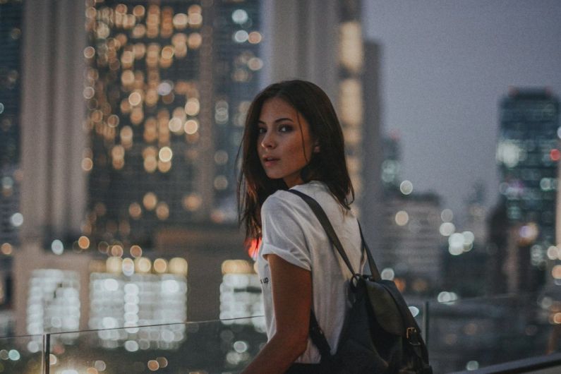 Older Buildings - woman in white t-shirt carrying black leather backpack