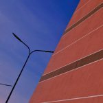 Placemaking - a tall red brick building next to a street light