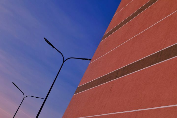 Placemaking - a tall red brick building next to a street light