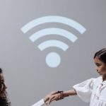 Wi-Fi - Mother and daughter with smartwatch and Wi-Fi symbol