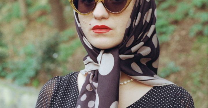 Pop-Up Parks - Woman in a Black Dress and Headscarf