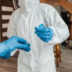 Post-Pandemic - Person in White Long Sleeve Shirt Wearing Blue Gloves